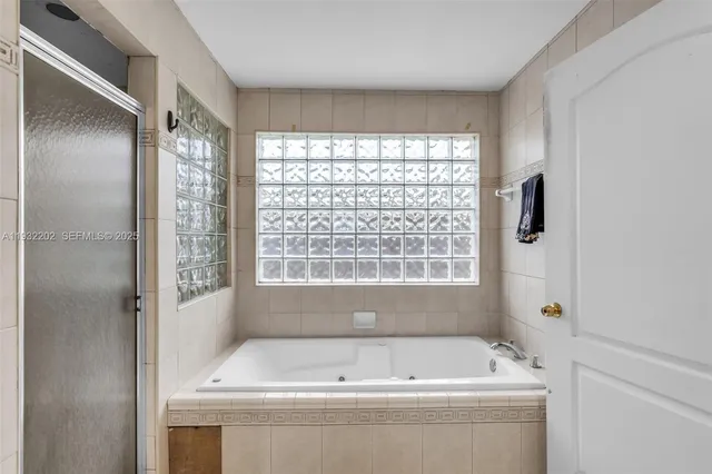 a bathroom with a bathtub and window