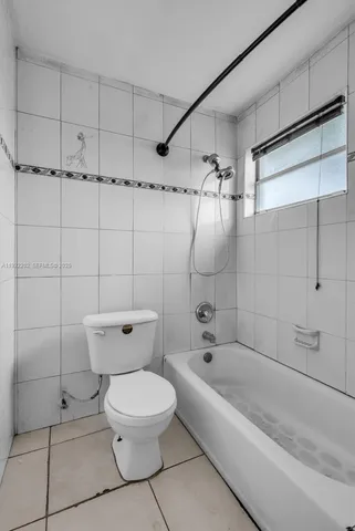 a bathroom with a toilet and shower