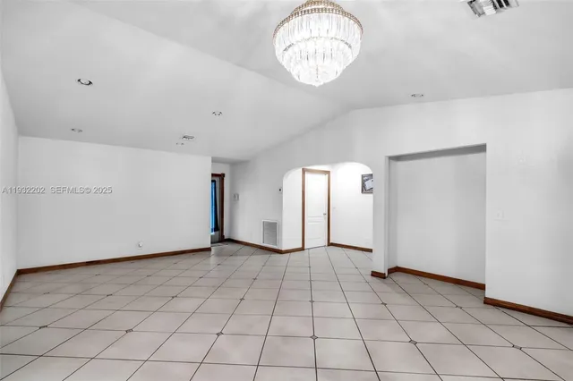 an empty room with a projector and wooden floors