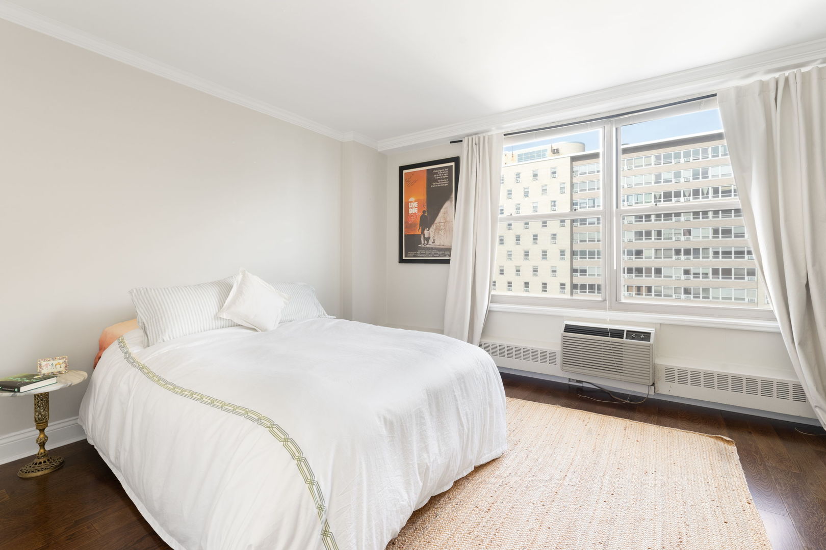 3900 North Lake Shore Drive, Unit 18F Chicago, IL 60613 - Photo 11 of 22 a spacious bedroom with a bed and a large window with wooden floor