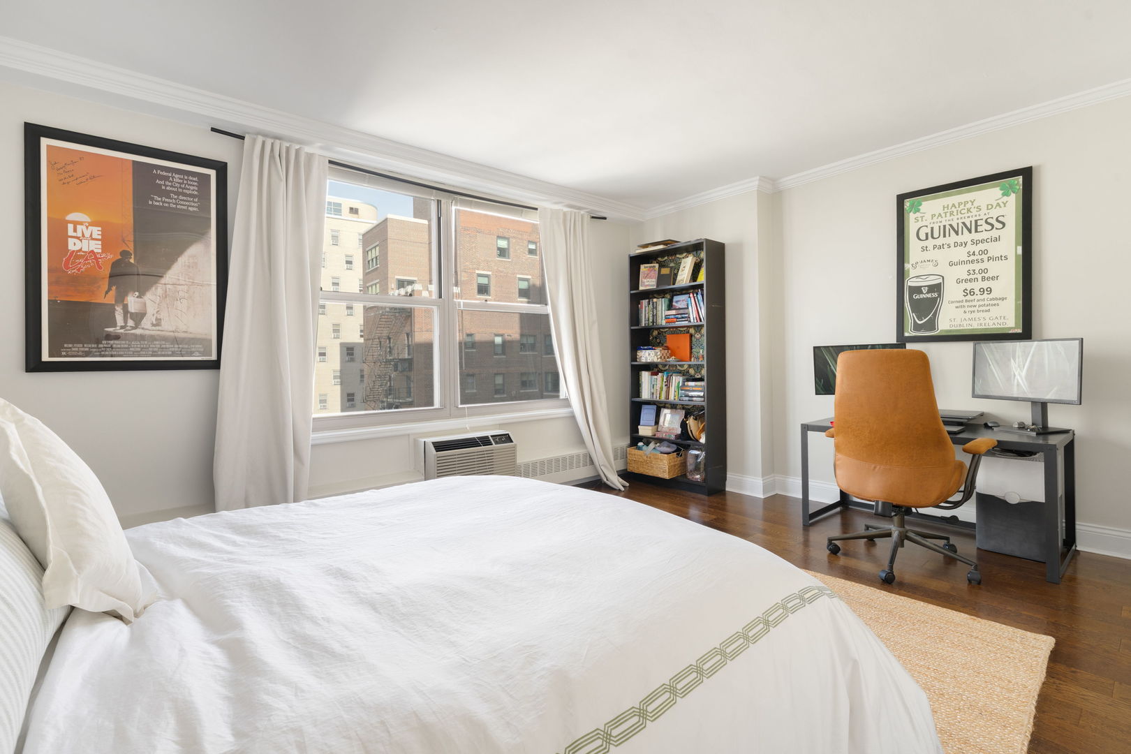 3900 North Lake Shore Drive, Unit 18F Chicago, IL 60613 - Photo 12 of 22 a bedroom with a bed a table and a large window