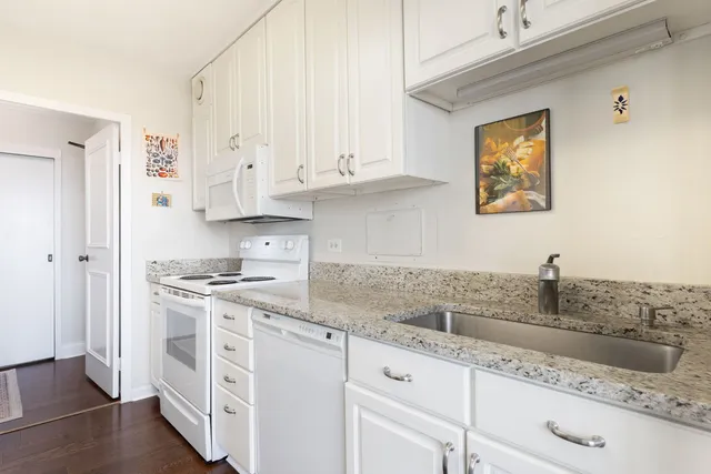 a kitchen with stainless steel appliances granite countertop a sink stove and cabinets