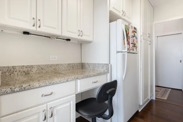 a kitchen with stainless steel appliances granite countertop a refrigerator and a cabinets