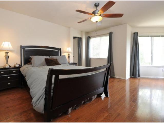 8121 Siringo Pass Austin, TX 78749 - Photo 6 of 9 Bedroom with dark wood-style flooring and a ceiling fan