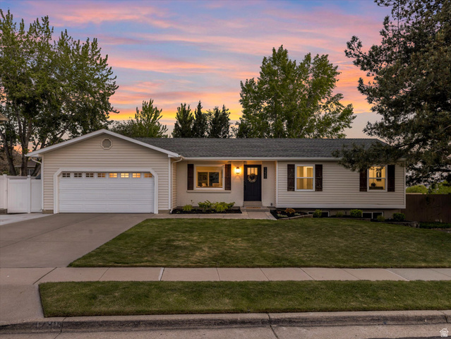1230 Crestridge Road Sandy, UT 84094 - Photo 1 of 1 Single-story home featuring light-colored siding, a dark roof, and a two-car garage with a concrete driveway