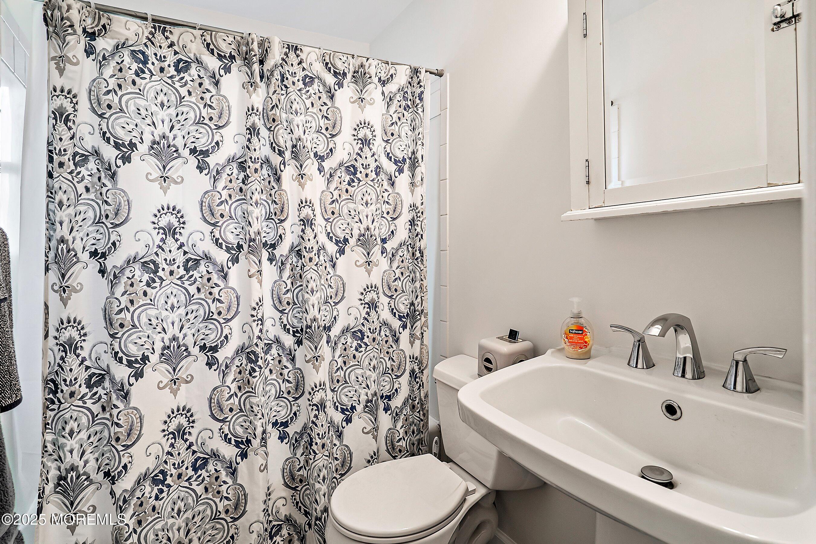 501 Stone Road Union Beach, NJ 07735 - Photo 14 of 30 a bathroom with a sink and a toilet