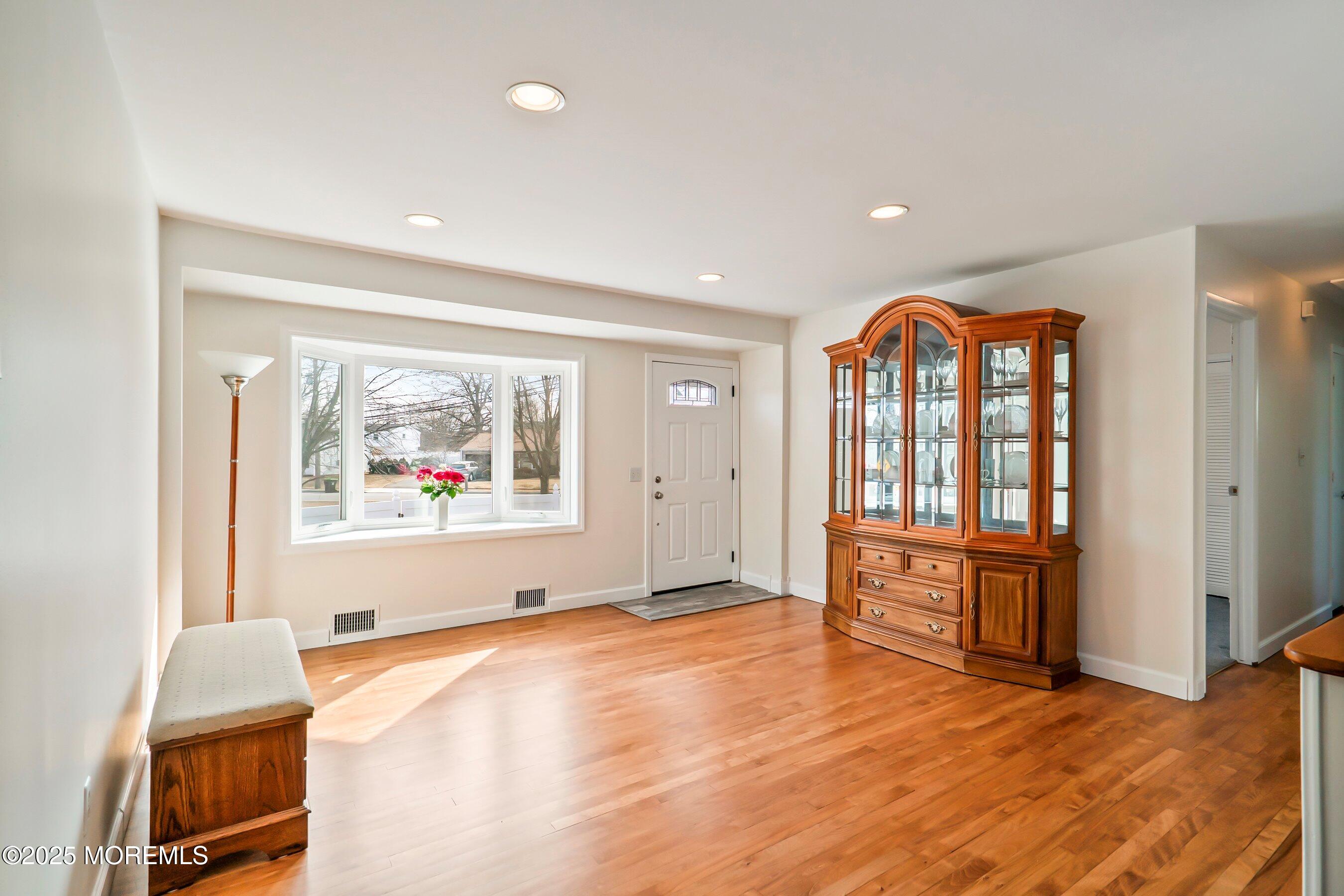 501 Stone Road Union Beach, NJ 07735 - Photo 2 of 30 a view of an empty room with a window and wooden floor