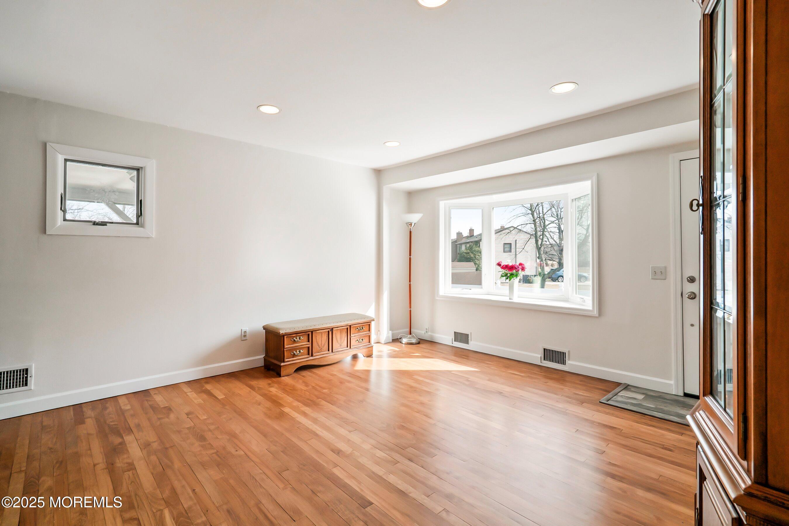 501 Stone Road Union Beach, NJ 07735 - Photo 3 of 30 a view of an empty room with wooden floor and a window