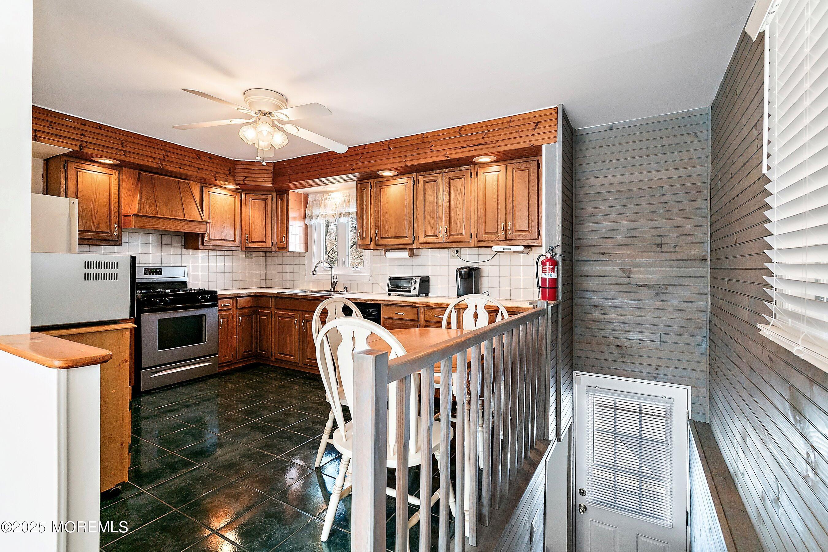 501 Stone Road Union Beach, NJ 07735 - Photo 6 of 30 a kitchen with granite countertop a sink appliances cabinets and a counter top space