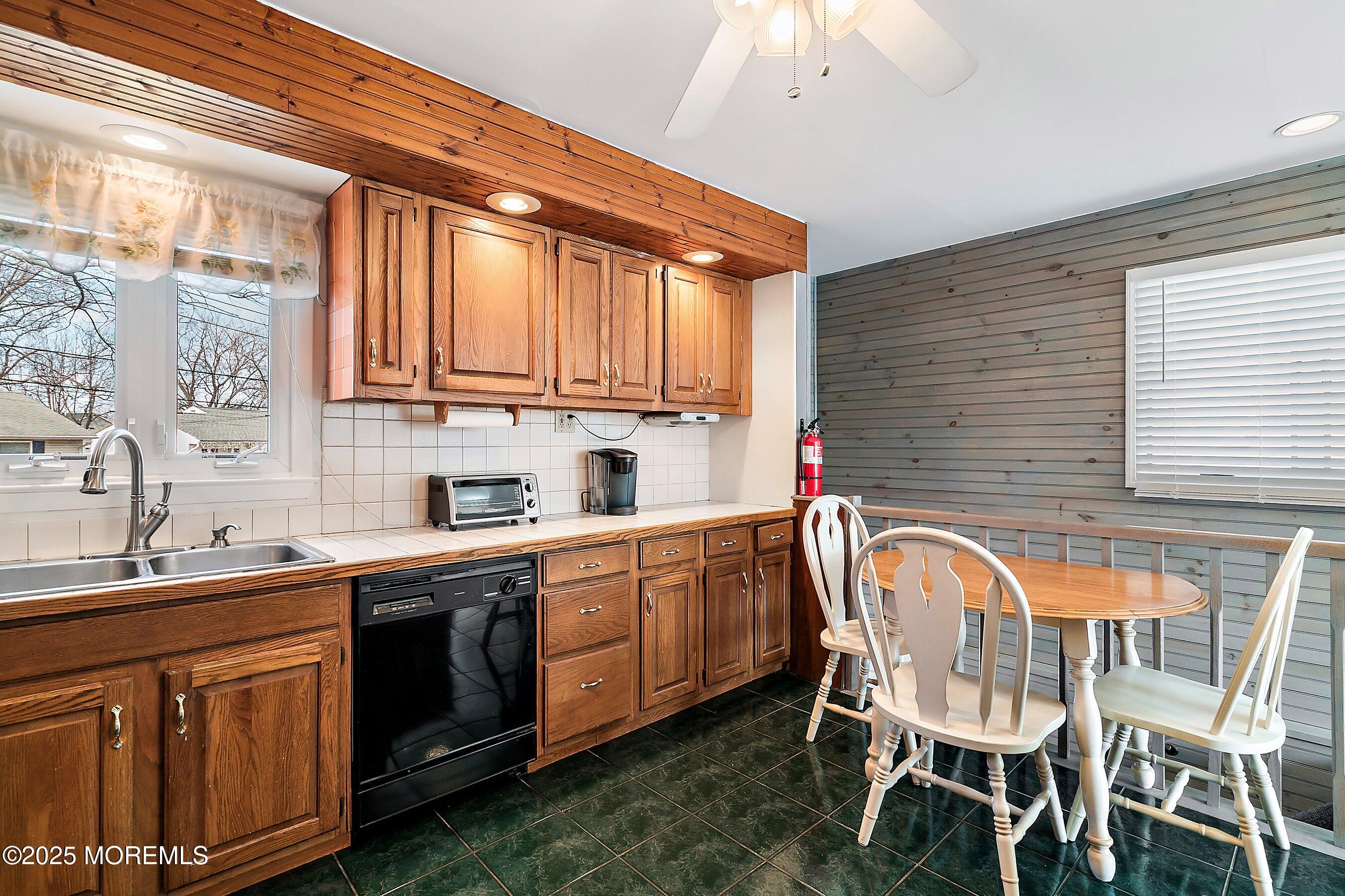 501 Stone Road Union Beach, NJ 07735 - Photo 9 of 30 a kitchen that has a sink and chairs in it