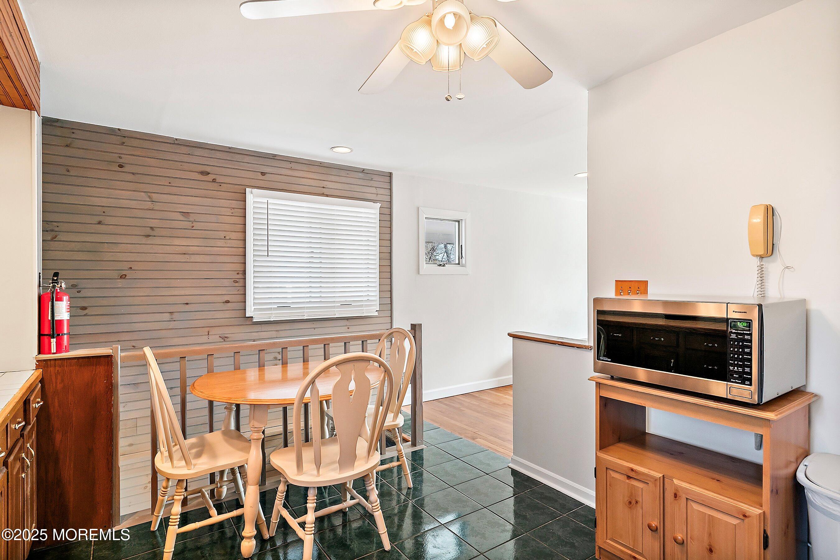 501 Stone Road Union Beach, NJ 07735 - Photo 10 of 30 a kitchen with stainless steel appliances kitchen island granite countertop a stove and a microwave