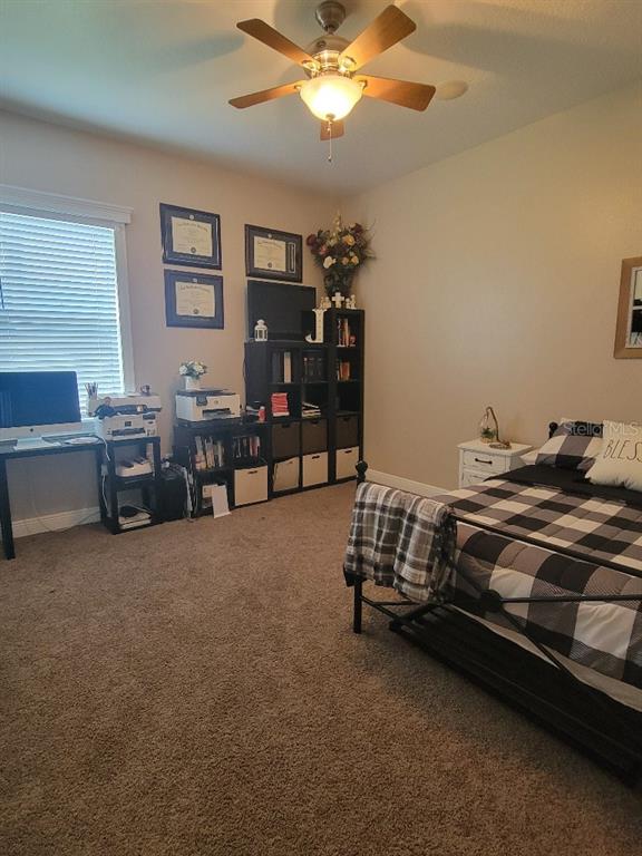 12625 Sweet Hill Road Polk City, FL 33868 - Photo 17 of 32 a bedroom with bed and window