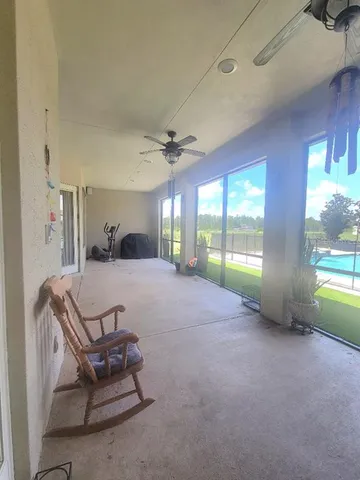 a living room with furniture and a floor to ceiling window