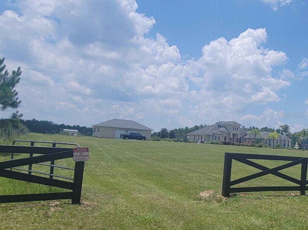 12625 Sweet Hill Road Polk City, FL 33868 - Photo 29 of 32 a view of a lake with a yard from a bench