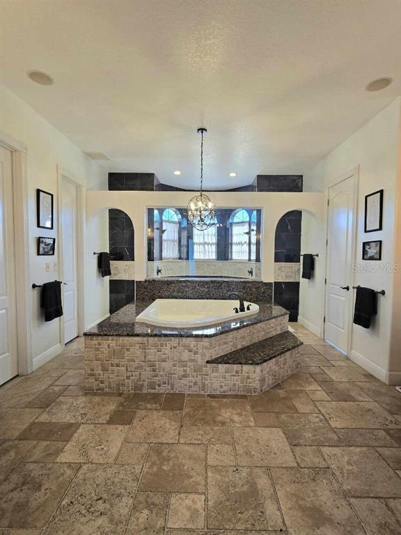 12625 Sweet Hill Road Polk City, FL 33868 - Photo 30 of 32 a view of a living room and kitchen with furniture