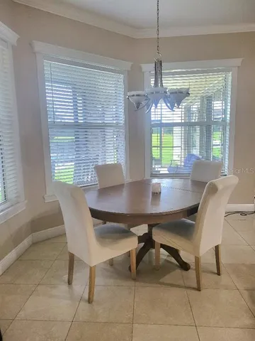 a view of a dining room with furniture window and outside view