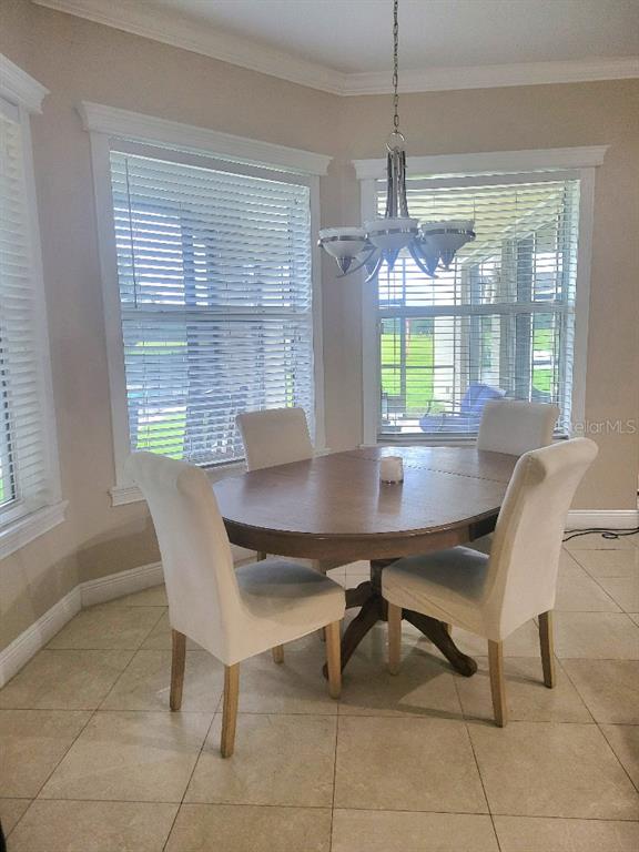 12625 Sweet Hill Road Polk City, FL 33868 - Photo 8 of 32 a view of a dining room with furniture window and outside view