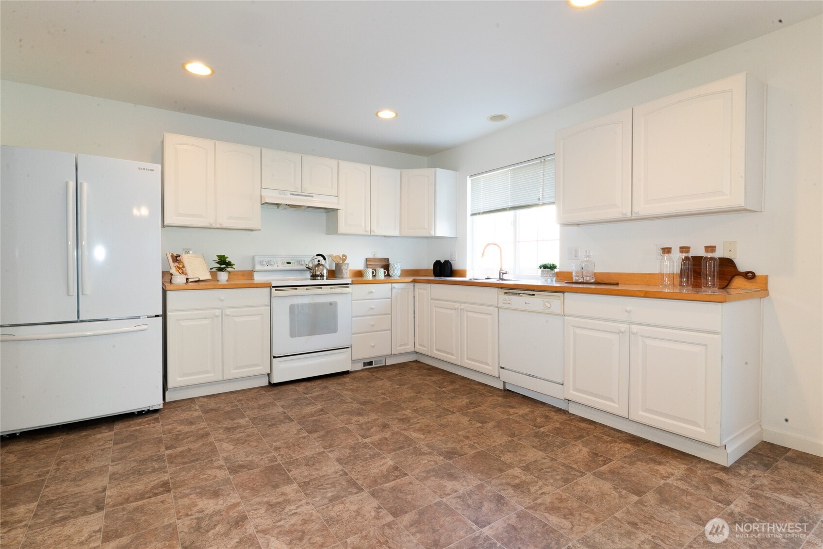 2322 Southeast 2nd Court Renton, WA 98056 - Photo 7 of 27 a kitchen with white cabinets stainless steel appliances and sink