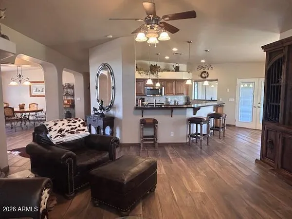a living room with furniture and kitchen view