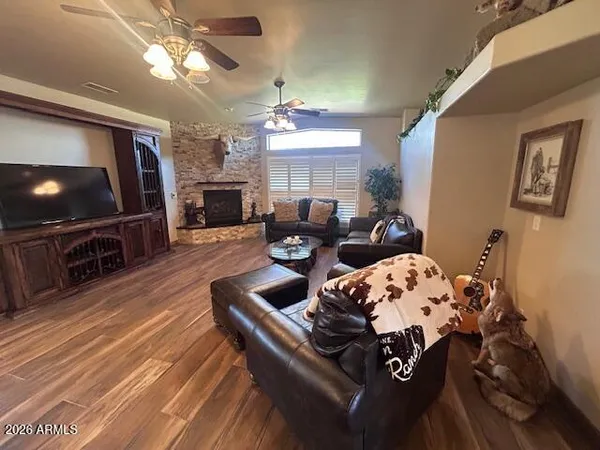 a living room with furniture a flat screen tv and a chandelier