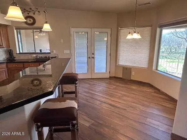 a room with wooden floor and windows