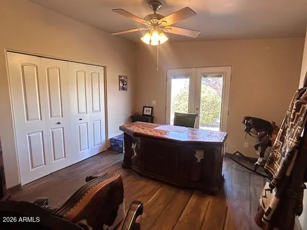 a room with wooden floors and windows