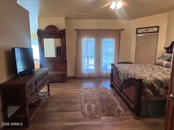 a living room with a bed furniture and a flat screen tv