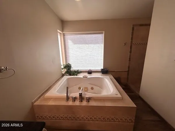 a bedroom with a bed and a mirror