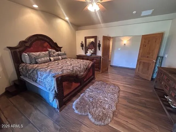 a bedroom with a bed and a mirror on dresser