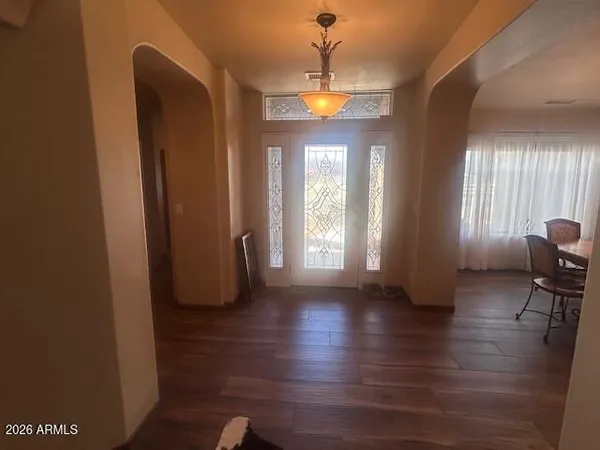 a view of a room with wooden floor and furniture