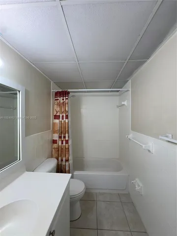 a bathroom with a toilet and shower