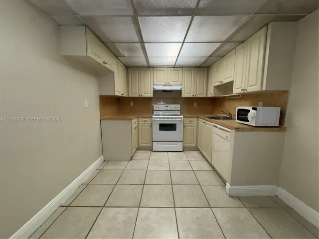 a kitchen with stainless steel appliances a sink a stove a microwave and cabinets
