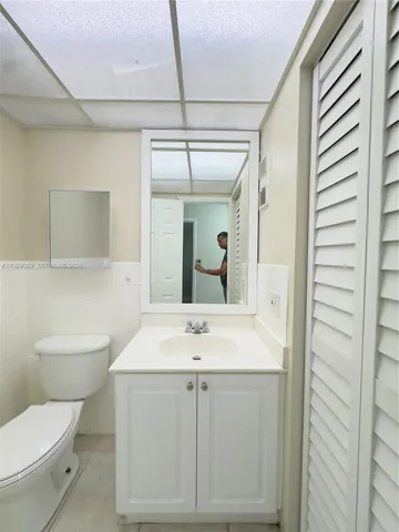 a view of bathroom with a toilet sink and mirror