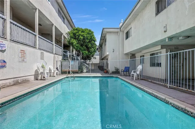 a view of a house with backyard and swimming pool