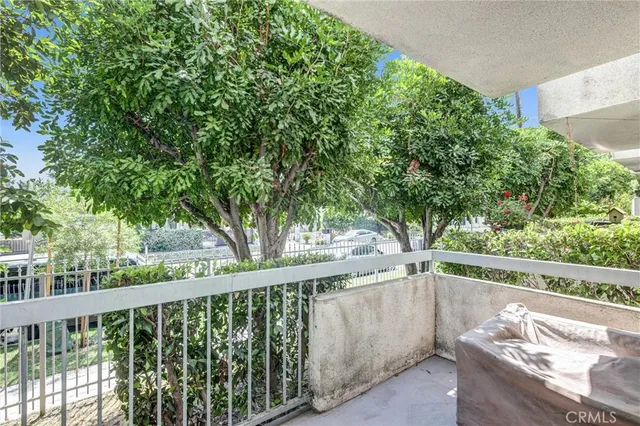 a view of balcony with wooden floor and outdoor seating