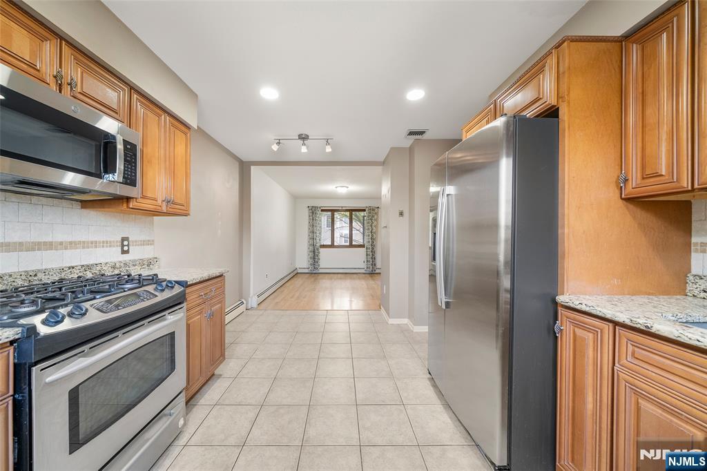 140 Allwood Road, Unit C Clifton, NJ 07012 - Photo 14 of 31 a view of a kitchen with a sink stove and cabinets