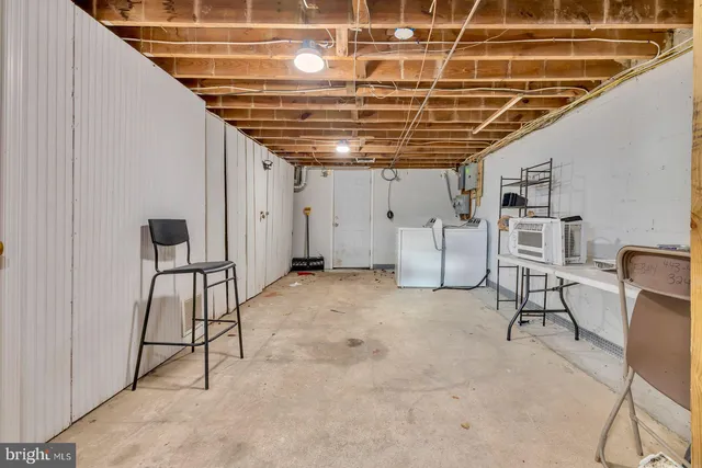 a bed sitting in a bedroom next to a white wall