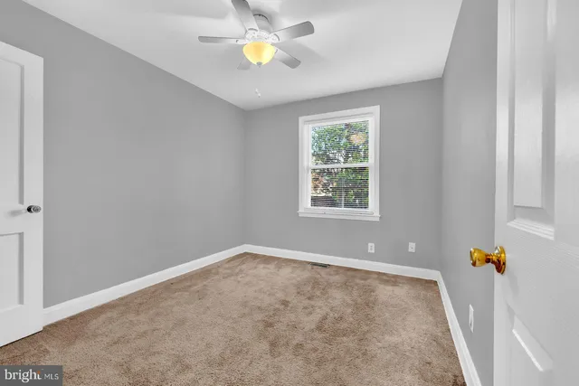 an empty room with a window and flowerpot