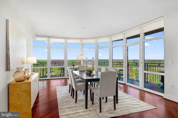 a dining room with furniture window and wooden floor