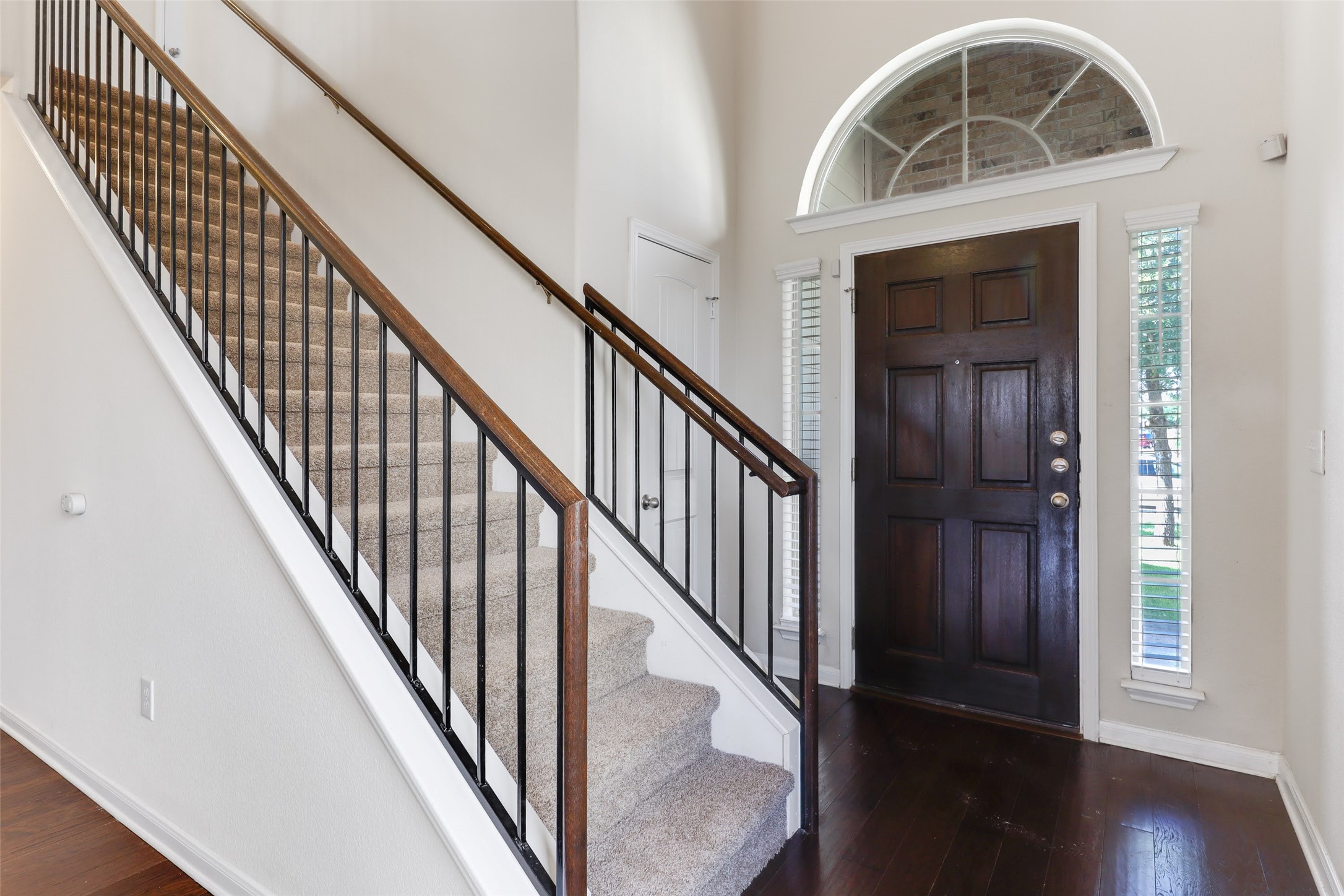 18705 Moreto Loop Pflugerville, TX 78660 - Photo 4 of 21 A grand entry with a sweeping staircase and a striking arched window above the front door.