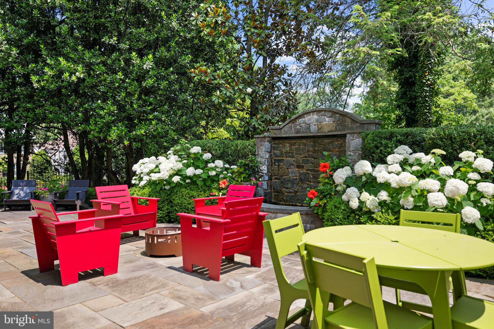 2931 Foxhall Road Northwest Washington, DC 20016 - Photo 53 of 62 a front view of a house with yard fire pit and outdoor seating