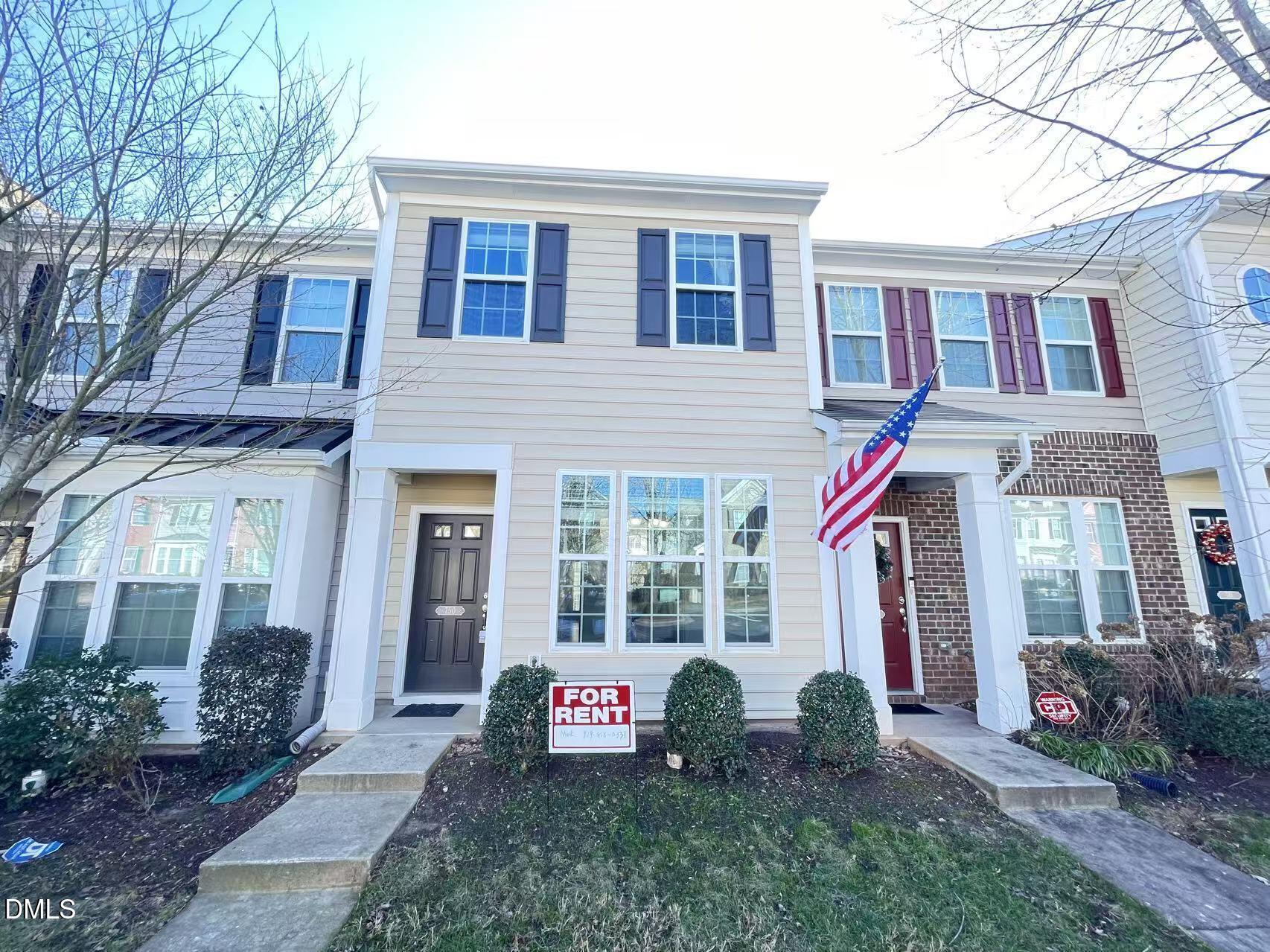 a front view of a house with a garden and plants