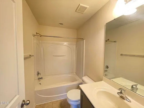 a bathroom with a sink toilet vanity and shower