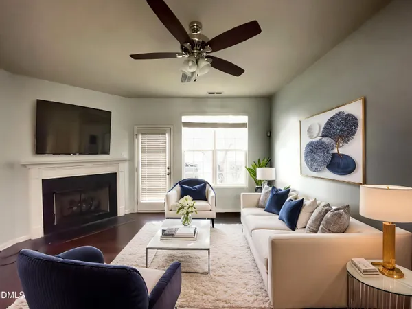 a living room with furniture a fireplace and a flat screen tv