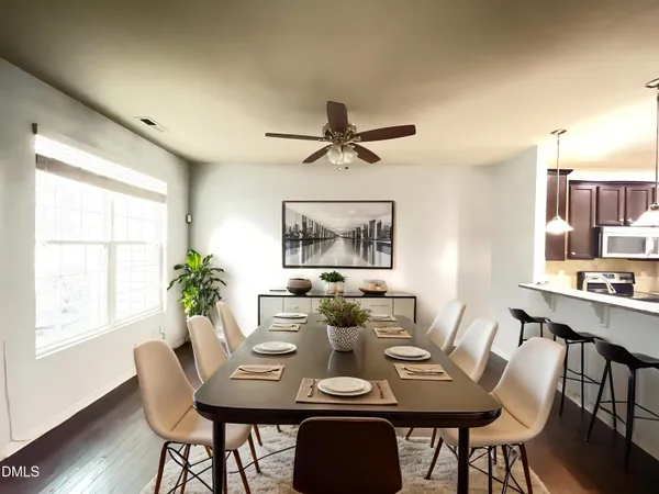a view of a dining room with furniture window and wooden floor