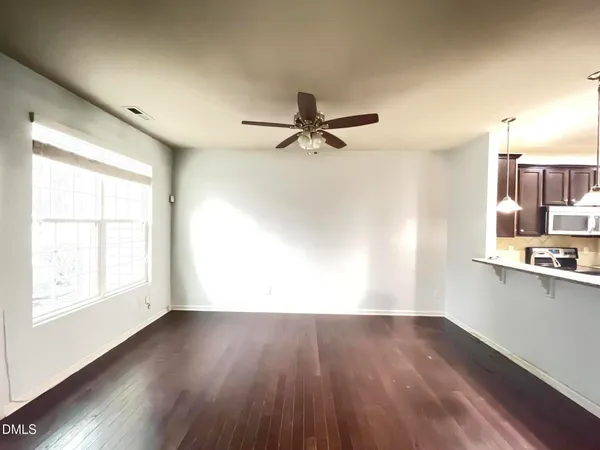 a view of a room with wooden floor and a window
