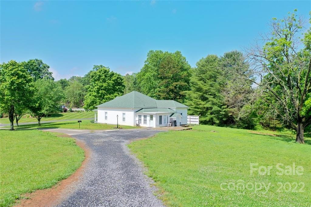 2139 Quaker Road Siloam, NC 27047 - Photo 12 of 35 a front view of a house with a yard