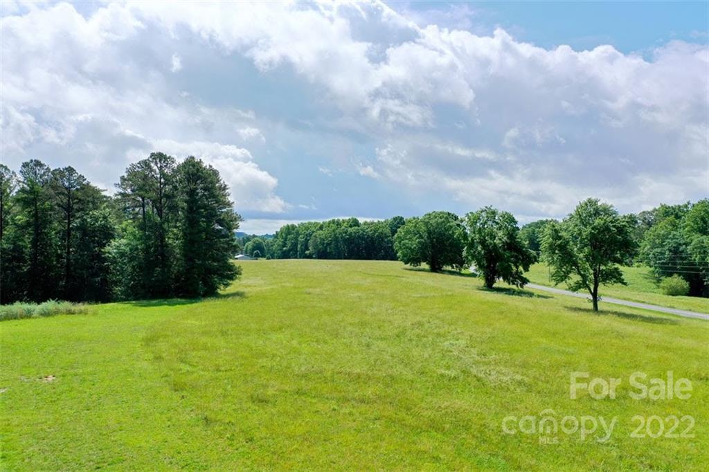 2139 Quaker Road Siloam, NC 27047 - Photo 14 of 35 a view of grassy field with trees in the background