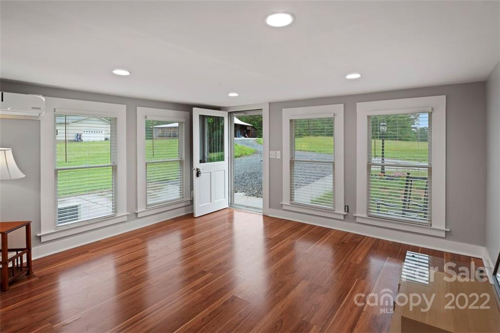 2139 Quaker Road Siloam, NC 27047 - Photo 17 of 35 an empty room with wooden floor and windows
