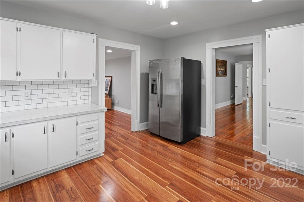 2139 Quaker Road Siloam, NC 27047 - Photo 19 of 35 a kitchen with stainless steel appliances granite countertop a refrigerator and cabinets